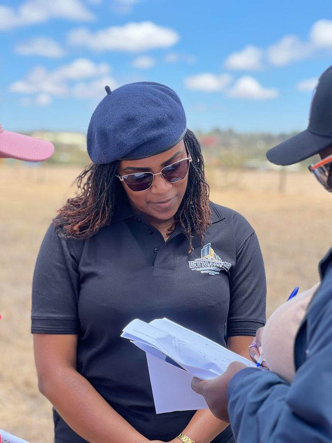 An Ethacah team member going through the land documents on site