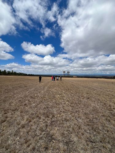 Open ground with water towers on the horizon